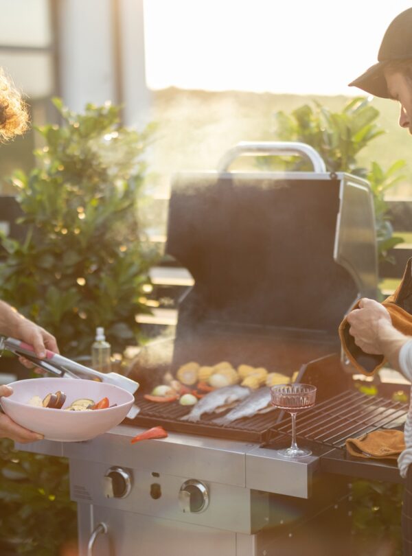 Guy grilling at backyard on a sunset