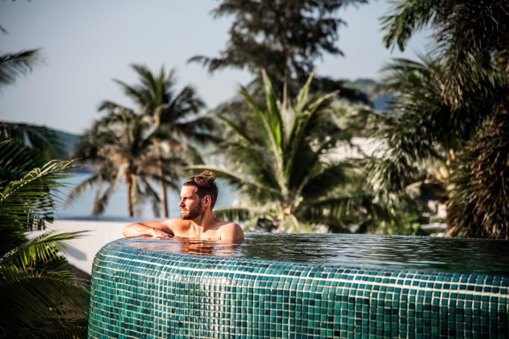 Handsome guy relaxing in swimming pool