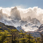 Low cloud over sunlit Fitz Roy mountain range in Los Glaciares National Park, Patagonia, Argentina