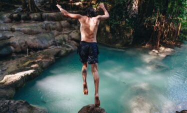 White man enjoying the waterfall