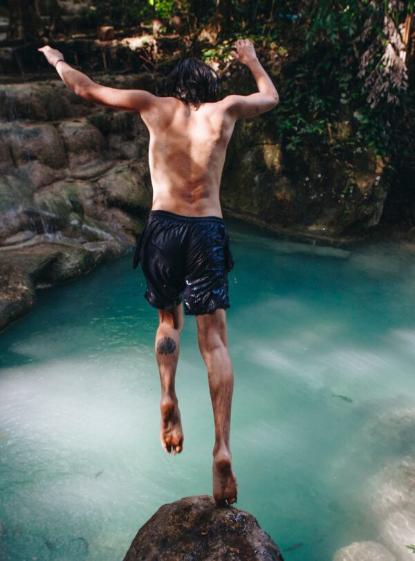 White man enjoying the waterfall