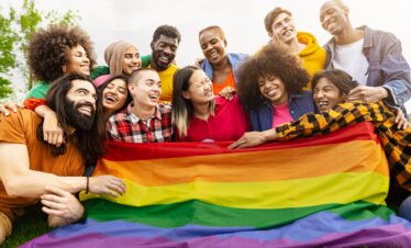 Happy diverse young friends celebrating gay pride day - LGBTQ community concept