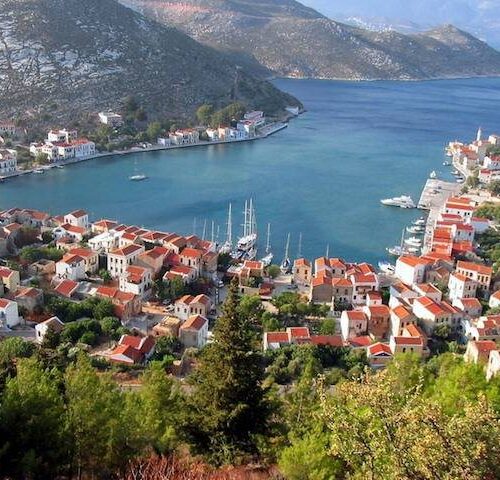 Colorful neoclassical houses surrounding Symi harbor in Greece