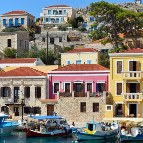 Colorful waterfront houses in Nimborio harbour on Halki, Greece