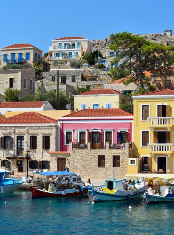 Colorful waterfront houses in Nimborio harbour on Halki, Greece
